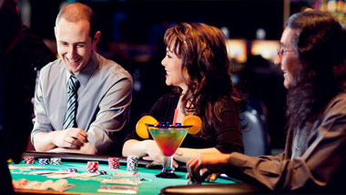 2 men and woman playing table games